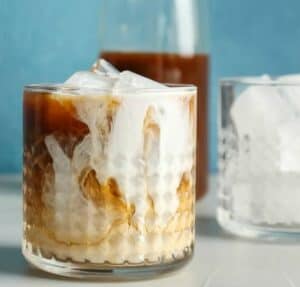 Glass with cold brew coffee, ice and cream