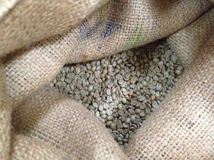 Green coffee beans in a coffee sack