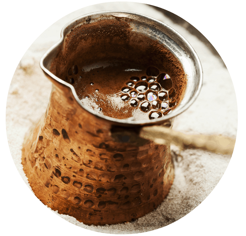 Turkish coffee in ibrik over hot sand