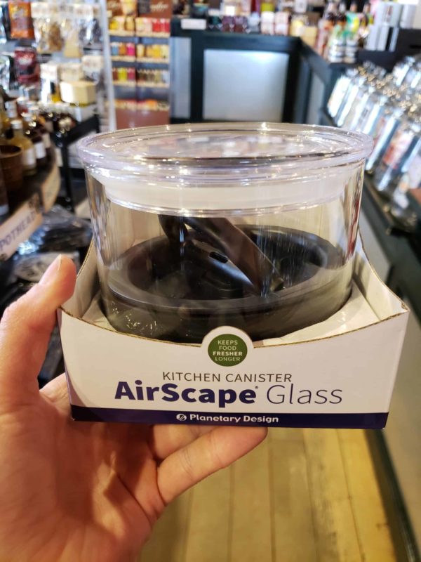 hand holding a Airscape Glass Canister with acrylic sealing lid, 4 inches high