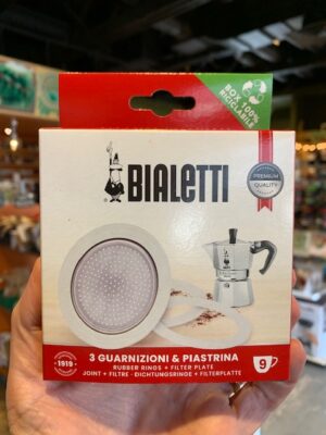 hand holding a box of bialetti 9 cup gaskets and filter plate