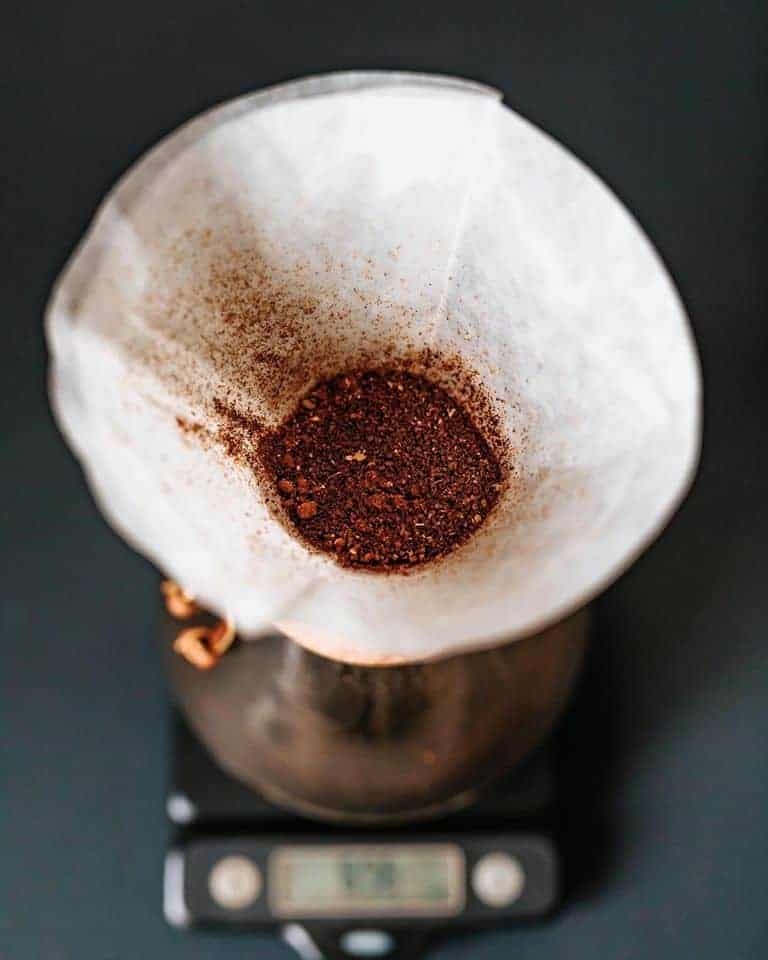 Looking down into a pourover that has a filter and ground coffee in it.