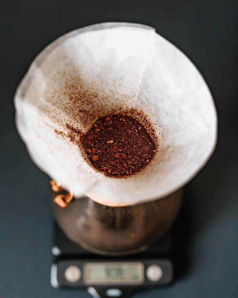 Looking down into a pourover that has a filter and ground coffee in it.