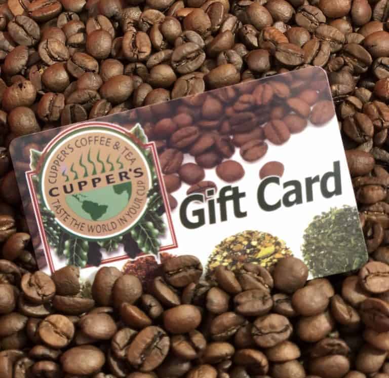 Cupper's Gift cards in a pile of roasted coffee beans.