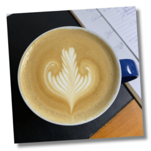 Overhead view of cappuccino art in blue mug