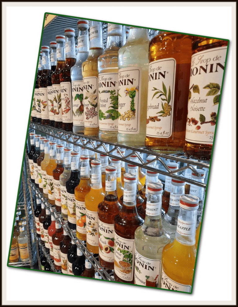 A wire shelf full of different flavours of Monin Syrups