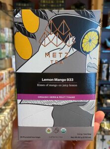 Hand holding Metropolitan Metz Tea Lemon Mango Box