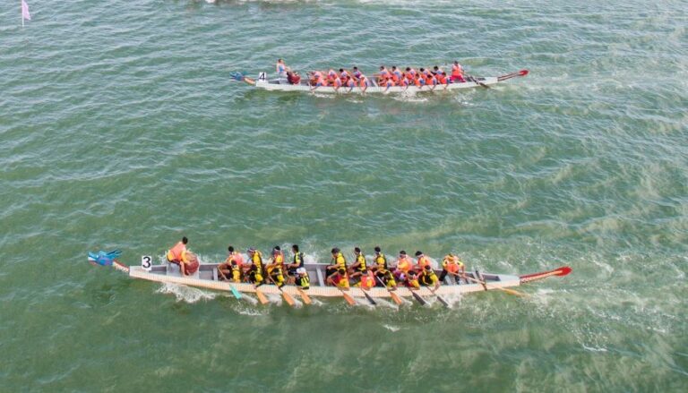 Two dragon boats racing on a lake