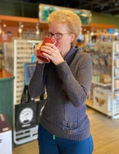 Nancy woman drinking tea or coffee from a red mug