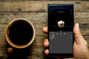 cup of coffee and a cell phone with coffee app