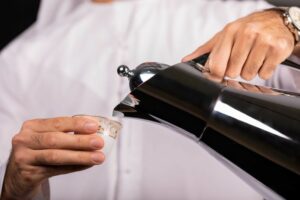 carafe of coffee being poured into a cup