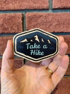 vinyl sticker of a mountain range with words Take a hike