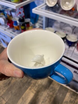 Creature Cup in Ocean Blue with a dolphin coming out of the bottom of the mug