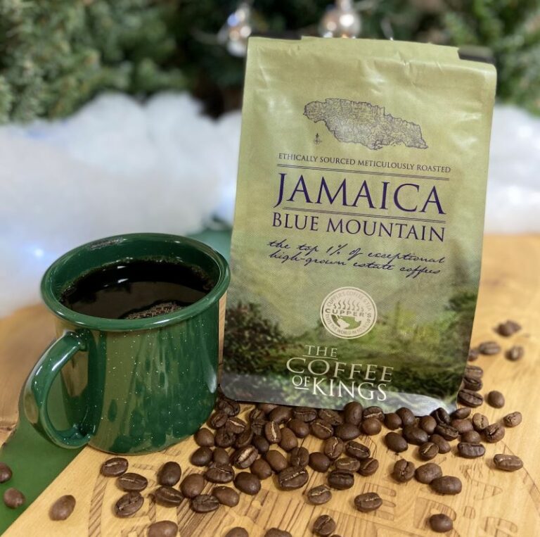 a bag of blue mountain Jamaican coffee with a green enamel cup