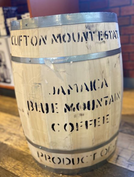 front of a Jamaican Blue Mountain Coffee Barrel