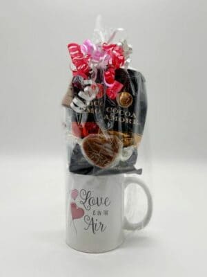 Valentines Basket Hot Chocolate Mug with assorted treats, wrapped in cellophane and ribbons