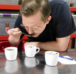 Josh B tasting coffee during a cupping