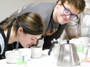 Micah and Jensen cupping coffee at Cuppers