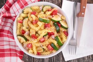 Spicy pasta salad in an bowl made with Cupper's hot sauce for easy gourmet recipes