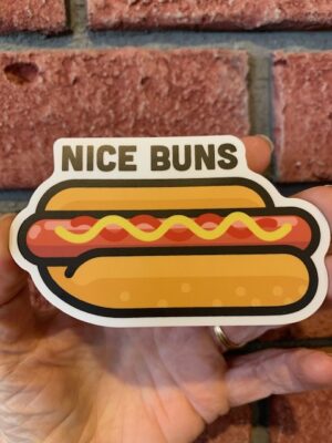Sticker nice buns over a hot dog with mustard