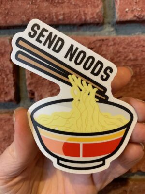 sticker send noods over a bowl of noodles and chopsticks