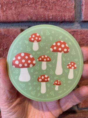 sticker mushroom circle with red & white mushrooms on a green background
