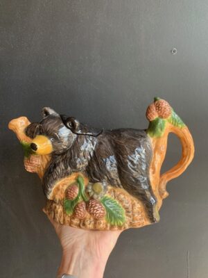 Black Bear Teapot made by Blue Sky being held by a hand