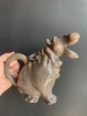 Hippo Teapot made by Blue Sky being held by a hand