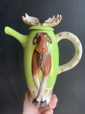 Moose Teapot made by Blue Sky being held by a hand