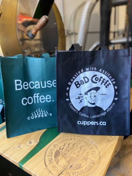 a Because Coffee and Bad Coffee reusable shopping bags at Cuppers to Make Your Café More Sustainable