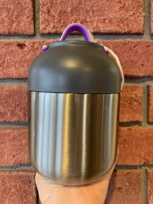 Thermal Food Jar Classic, 700 mL is brushed metal and a plastic bowl lid. The lid has a pink & purple handle.