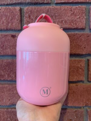 Thermal Food Jar Rose, 700 mL is pink with sparkles and a pink plastic bowl lid. The soft rubber handle is also pink.