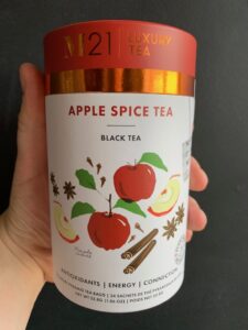 M21 Apple spice tea being held by a hand