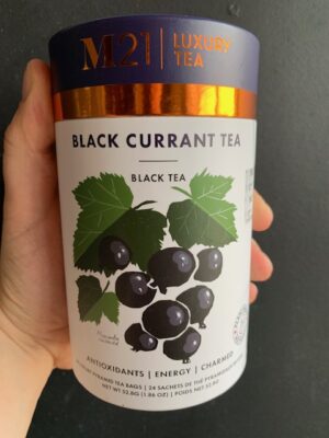 M21Black Current tea being held by a hand