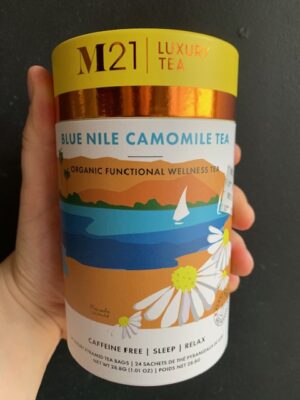 M21 Blue Nile Camomile tea being held by a hand