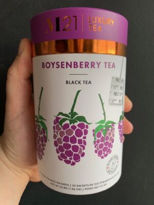 M21 Boysenberry Tea being held by a hand