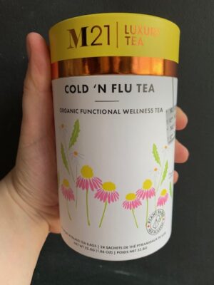 M21 Cold 'N Flu Tea being held by a hand