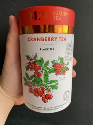 M21 Cranberry Tea being held by a hand