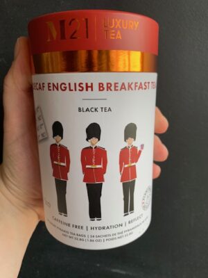 M21 Decaf English Breakfast Tea being held by a hand