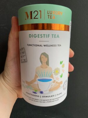 M21 Digestif Tea being held by a hand