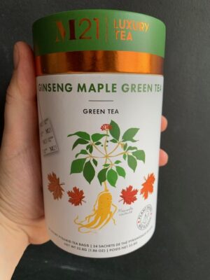 M21 Ginseng Maple Green Tea being held by a hand