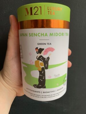 M21 Japanese Sencha Midori Green Tea being held by a hand