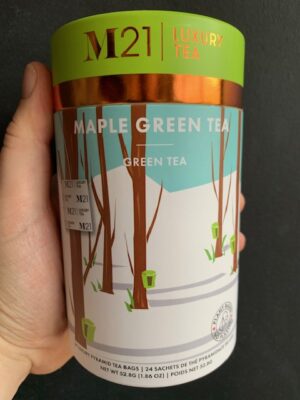 M21 Maple Green Tea being held by a hand