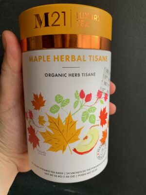 M21 Maple Herbal Tisane Tea being held by a hand