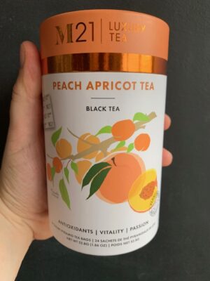 M21 Peach Apricot Tea being held by a hand