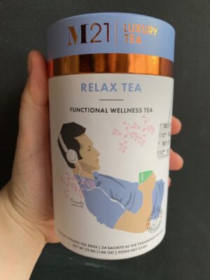 M21 Relax Tea being held by a hand