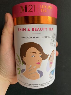 M21 Skin & Beauty Tea being held by a hand