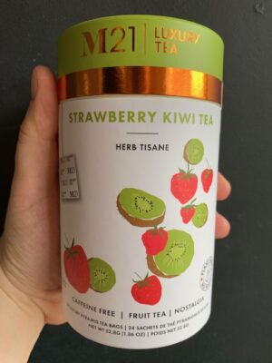 M21 Strawberry Kiwi Tea being held by a hand