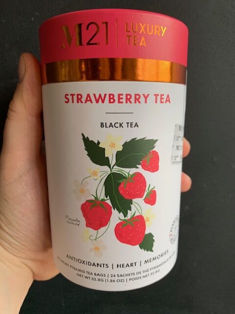 M21 Strawberry Tea being held by a hand