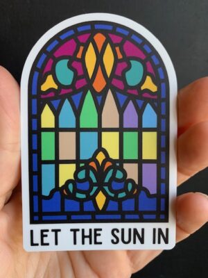 sticker of a stained glass window and text 'let the sun in'